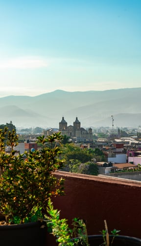 Rooftop terrace with sweeping mountain and city views at dusk